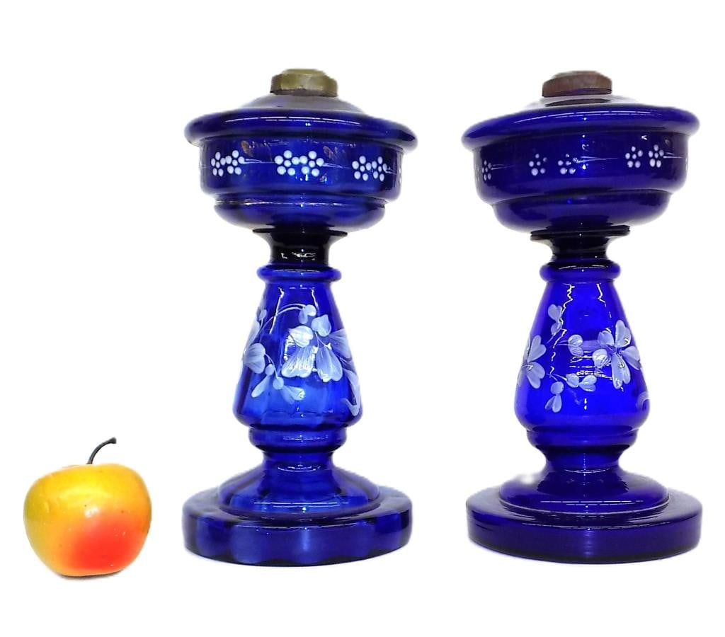 19TH CENTURY FRENCH COBALT GLASS OIL LAMPS: Pair 19th Century French Victorian Cobalt Blue Glass Oil Lamps. Hand Blown and Enamel Painted Floral Decoration with Golt Accents. Height 11" x 5.50" x 5.50" each 4 lbs total weight