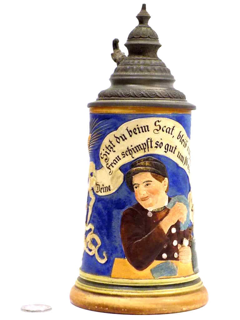 GESCHUTZT GERMAN GAMBLER SAYING BEER STEIN: Antique German Pottery Beer Stein. Raised Relief Decoration of a Gambler With Playing Cards, Pipe and Beer Stein. German Saying. 1/2 Liter. Fancy Pewter Lid. Signed Gesetzlich Geschutz 1405. Height 9"