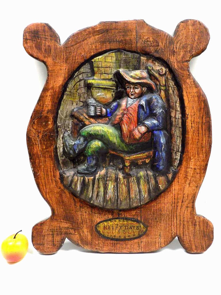 EDWARD KENNEDY HAPPY DAYS FOLK ART PLAQUE: Edward Kennedy American 20th Century - 1950's American Folk Art Plaque. Hand Relief Carved and Painted Pine Wood. Entitled Happy Days. Depicting an Interior Scene With Bavarian Drinker Seated With Bee