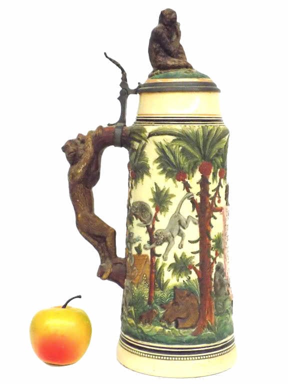 BIG GERMAN JUNGLE MONKEYS BEER STEIN 2 LITER: Big Antique German Pottery 2 Liter Beer Stein. Surrounding Relief Scenes Depicting Monkeys and Jungle Palm Trees. Monkey Holding Stein Finial, Monkey Handle. Saying Translation Reads: It is better to 