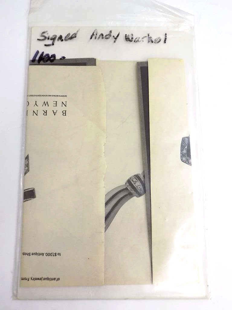 BARNEYS NEW YORK AD SIGNED BY ANDY WARHOL: Vintage Barneys New York Advertisement for Brilliant Antique Bows Hand Signed / Autographed By Andy Warhol in Pencil. Calvin Klein Ad on rear. Provenance: New York Estate, Obtained in Person.