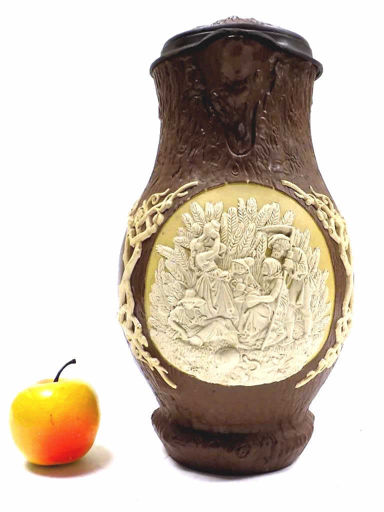 BIG METTLACH BEER STEIN No. 1028 HARVEST BY FOLTZ: Large Mettlach Pottery Beer Stein No. 1028. Etched Harvest Scene with Figures Attributed to Artist Ludwig Foltz II. Saying Reads: After Work Troubles and Sweat I Command You To Drink Out of Me, But Ne