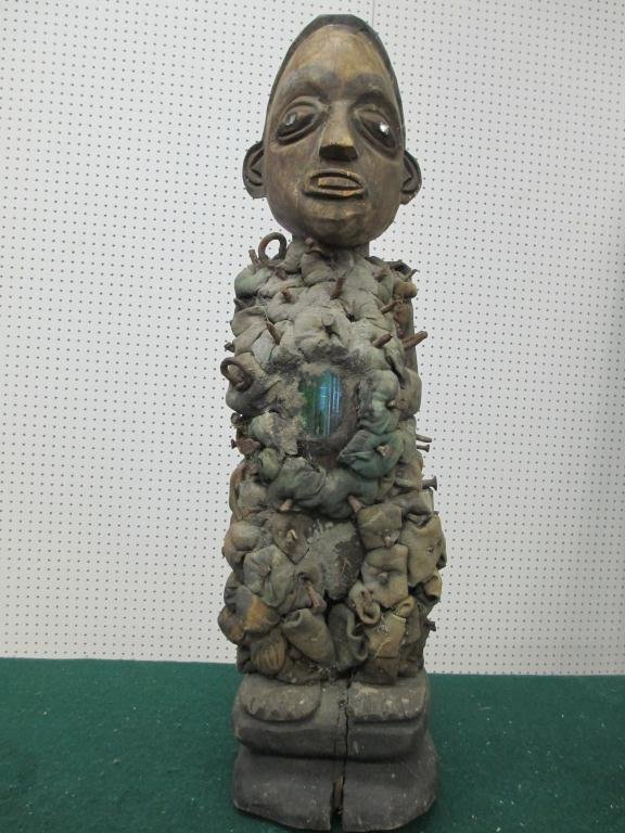 NKISI NKONDE POWER FIGURE FETISH - KONGO TRI: 19th Century Nkisi Nkonde carved figural wood power figure fetish statue with glass & nails. Green glass passage way for spirits . Kongo tribe Congo Central Africa . H 22"