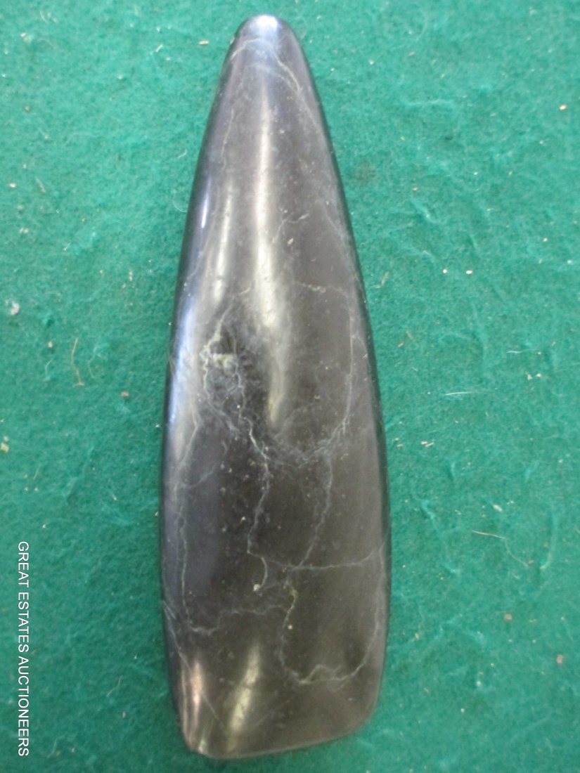 ANCIENT CEREMONIAL STONE AXE DOMINICAN REPUBLIC: Superb polished and form veined, dense black stone ceremonial axe, small chip on corner of blade. Dominican Republic. Quality property of a high Cacique. 1200- 100 A.D.