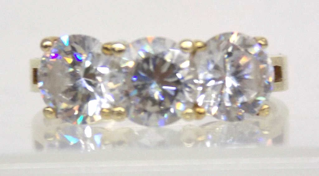 14K GOLD BRILLIANT CUT TRIPLE STONE RING: 14k Gold Triple White Stone Fashion Ring. Brilliant Cut White Stones. CZ or White Sapphires ? Illegible Stamp Inside. Size 6.5