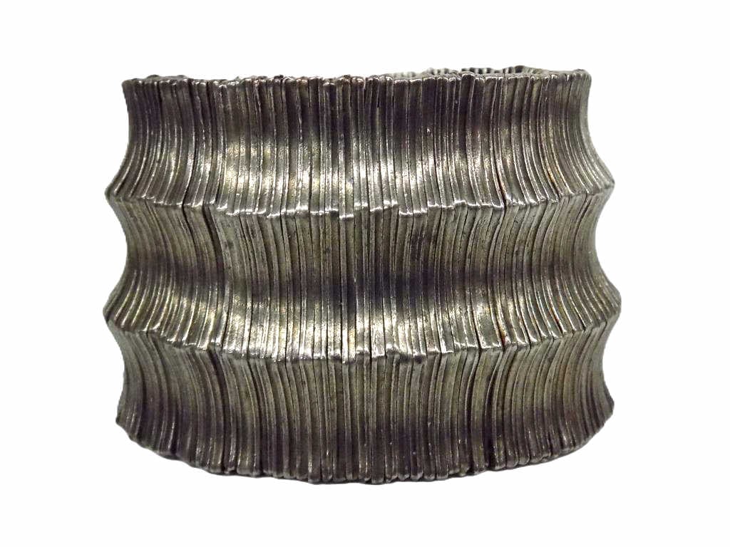 MIDCENTURY MODERNIST SILVER FASHION BRACELET: Midcentury Modernist Sculpted Silver Metal Fashion Bracelet. Expandable One Size Fits All. Signed Metal Pointu's. Height 2" x .25" x 3.50" unstretched. 259 grams