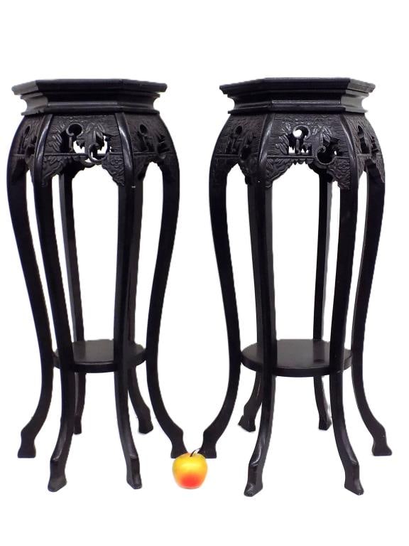 ANTIQUE CHINESE HEXAGONAL CARVED STANDS: Antique Pair of Chinese Hexagonal Ebony Wood Stands. Surrounding Carved Panels Depicting a Praying Figure with Blossoms. Each with Lower Shelf. Measurements: 29.50" x 12" x 12" 7 lbs and 29.50" x 12" 