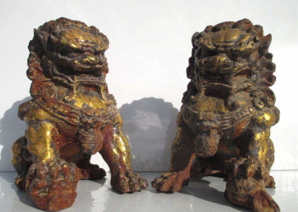 PAIR ANTIQUE CHINESE GILT IRON FOO DOGS: Pair Antique gilt iron Chinese foo dogs. Male & Female . Approximate H 6.50" x L 6.50".