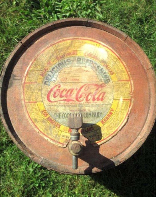 COCA COLA SYRUP BARREL 10 GALLON KEG: Late 19th Century Coca Cola 10 gallon syrup barrel. Original lithographic label with 7 cities. Old red wash with original stopper. H 21" x W 13"