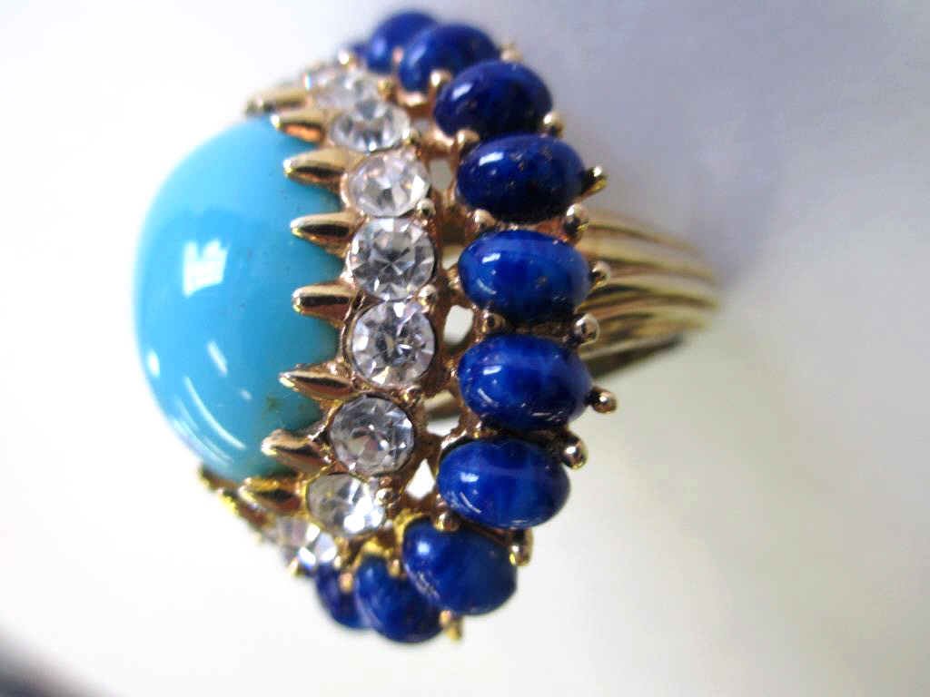 VINTAGE JOMAZ LARGE COCKTAIL RING: Vintage cocktail ring. Simulated diamonds , lapis & persian turquoise gemstones set in gold gilt metal, signed Jomaz, circa 1960s, size 6, 1 ½" across, ¾" above the finger.