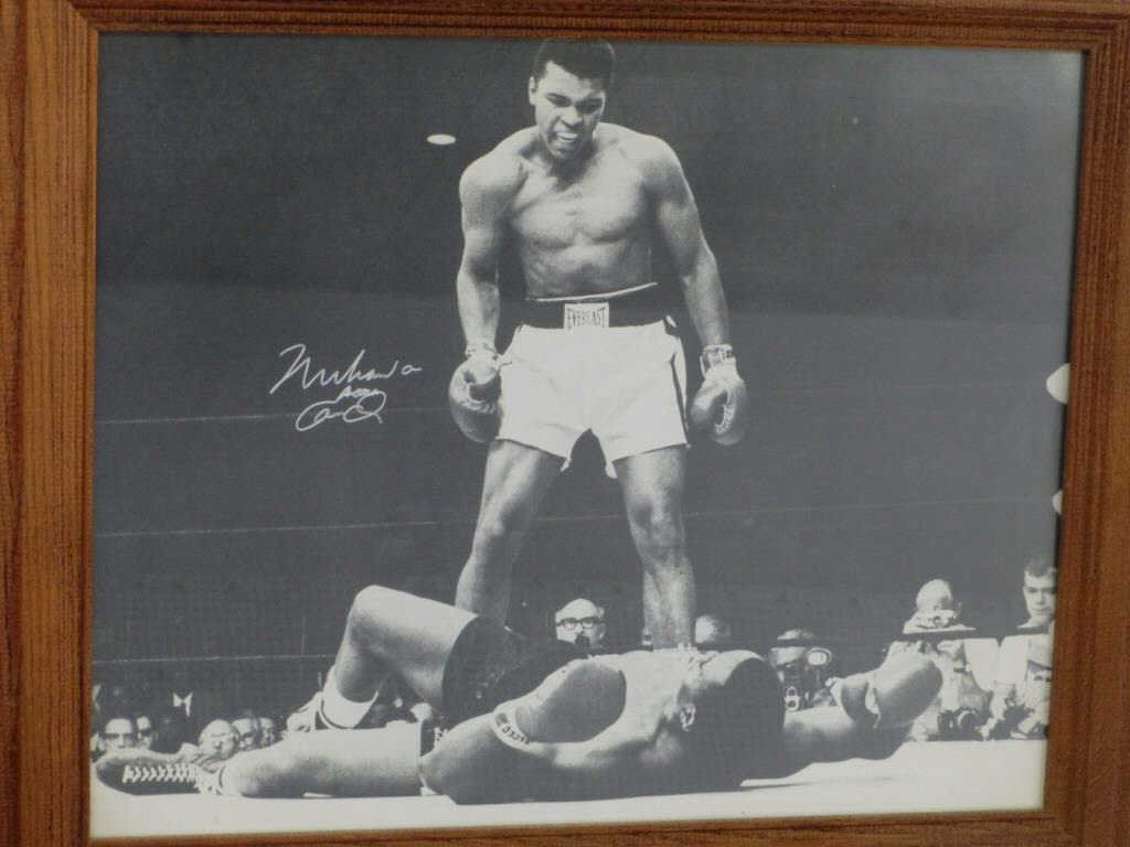 MUHAMMAD ALI CASSIUS CLAY AUTOGRAPHED PHOTO: Autographed action photograph of Legendary Boxing Icon standing victorious in the ring. Rare double signature Muhammad Ali Cassius Clay . 15.50" x 19.50". Comes with Park West Gallery authenticity ori