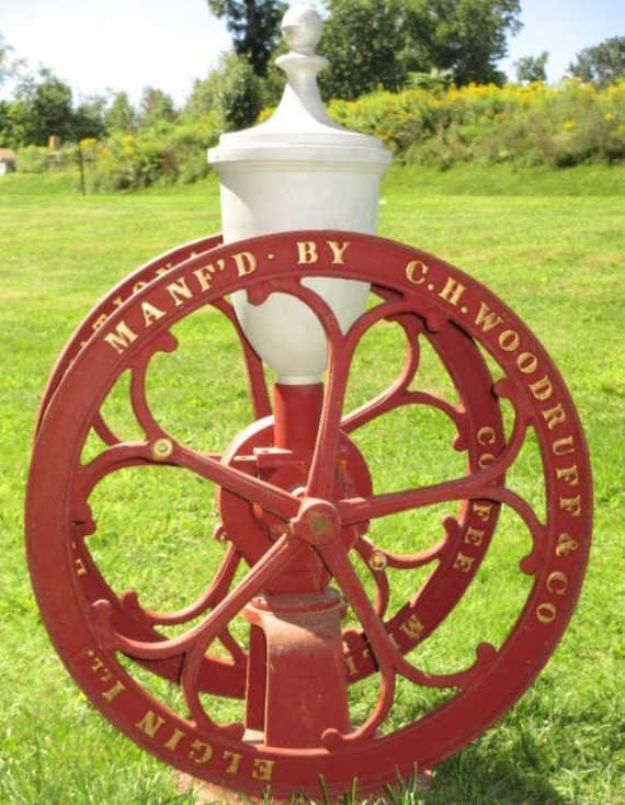 ELGIN NATIONAL COFFEE MILL C.H. WOODRUFF: Elgin National Coffee Mill Grinder C.H. Woodruff & Co. Later model. finial H 40.50" x L 27.50". Please contact an outside shipper on this lot.