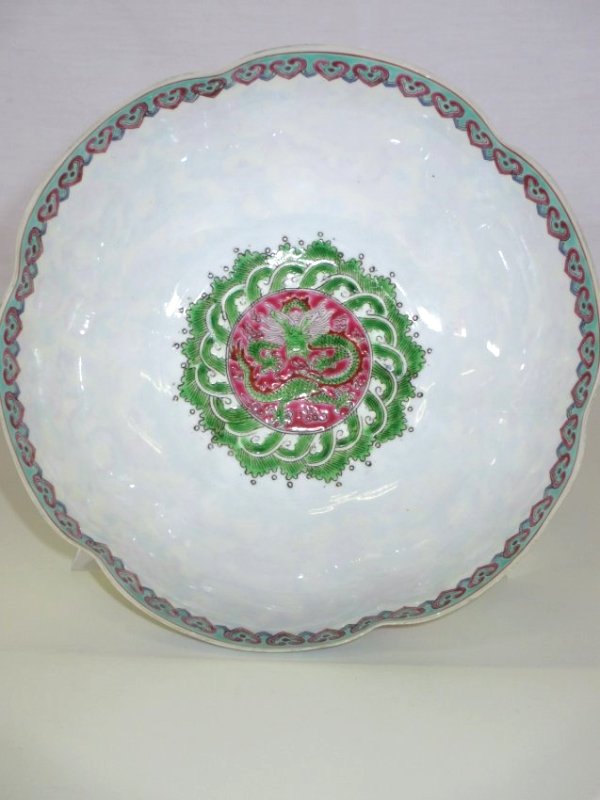 CHINESE FAMILLE JUANE EGGSHELL LOBED DRAGON BOWL: Chinese Famille Juane eggshell porcelain dragon bowl . Lobed form, decorated all around with dragons , clouds , lotus , flowers with imperial yellow background. Base mark. Approximate H 3" x D 7 1/2".