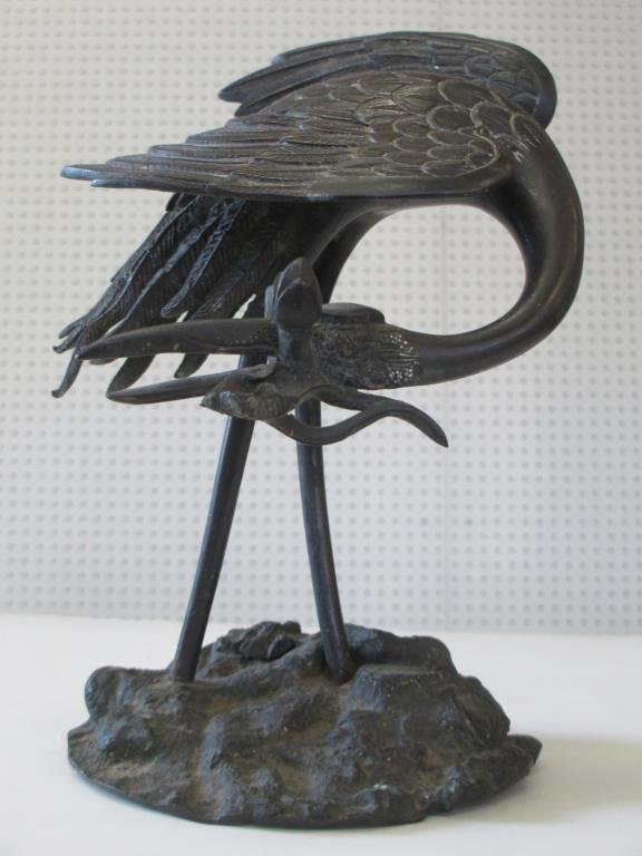 EDO / MEIJI PERIOD JAPANESE BRONZE CRANE: Edo / Meiji period Japanese bronze crane . Standing crame with Lotus plant in mouth. Warm dark patina. H 9".