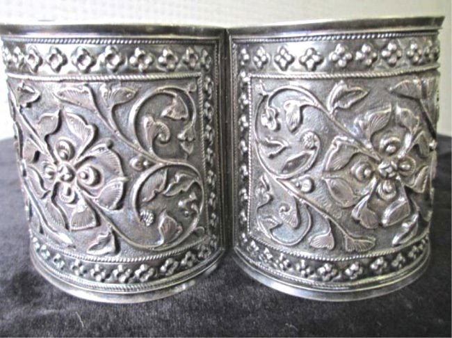 PERSIAN SIGNED SILVER CUFF BRACELET: Antique Persian Silver repousse cuff bracelet . Floral design with ropetwist borders & rosettes . Locking open / close hinge. Signed H.T. with persian marks. H & D 2.50" . 2.25 Troy Oz