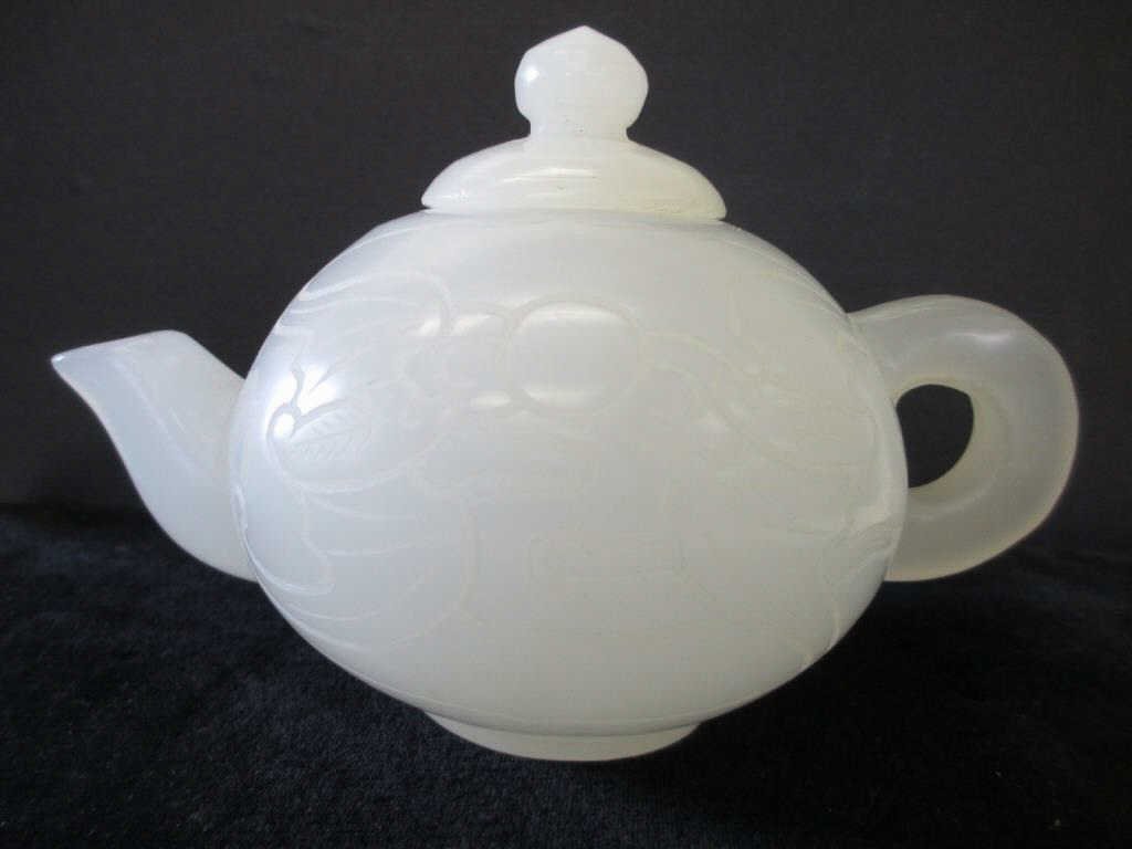CHINESE MUTTON FAT CARVED JADE TEA POT: Chinese mutton fat carved jade tea pot . Pair of carved flying birds or bats with trees on the obverse. H 4" x L 6".