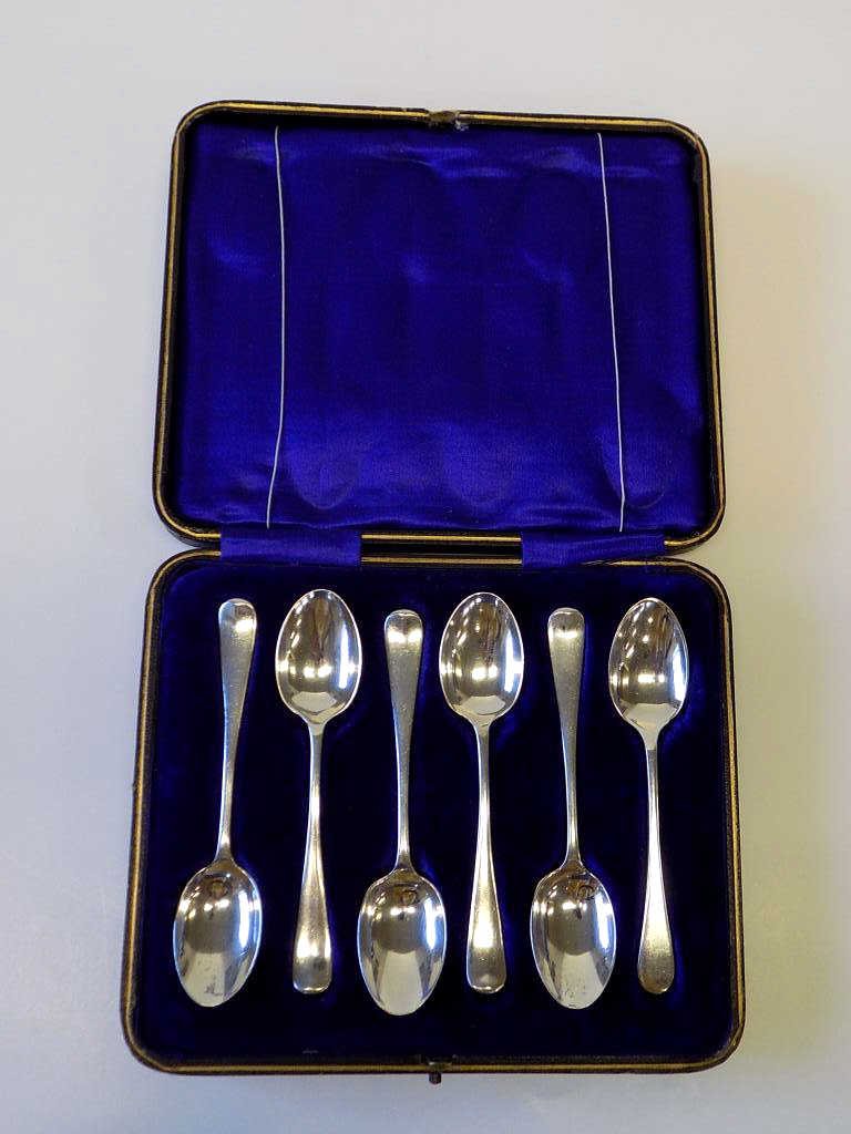 ENGLISH BOXED DEMITASSE STERLING SPOONS SET: Circa 1910-1911 English boxed demitasse Sterling Silver spoons in original cobalt blue velvet fitted tooled leather snap closure box. Set of 5 with passants. 1 replacement.
