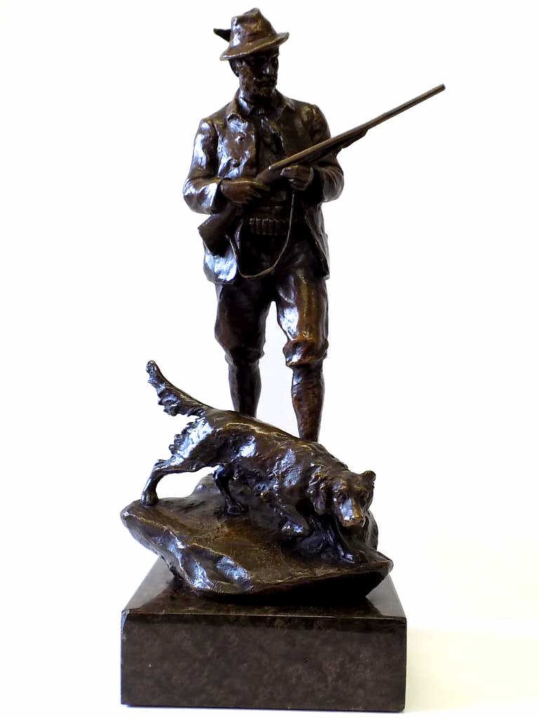HANS MULLER - HUNTER WITH DOG BRONZE STATUE: Hans Muller - German 1873-1937 - Antique Bronze statue of a Hunter holding shotgun with hound dog . Signed base. H 16". 19 1/2" with brown speckled marble base.