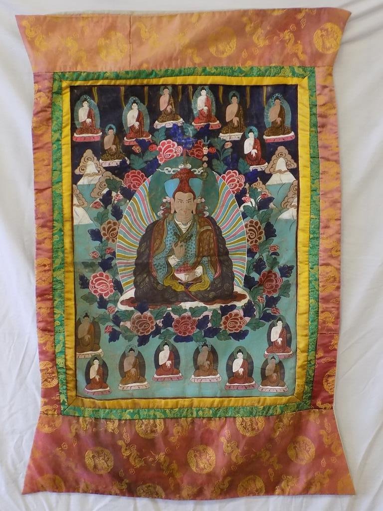 LARGE CHINESE TIBETAN BUDDHIST THANGKA: Chinese Tibetan buddhist Thangka . Hand painted canvas. Stitched silk borders with gold thread dragon motifs . Inscribed on reverse. H 46" x L 28 1/2".