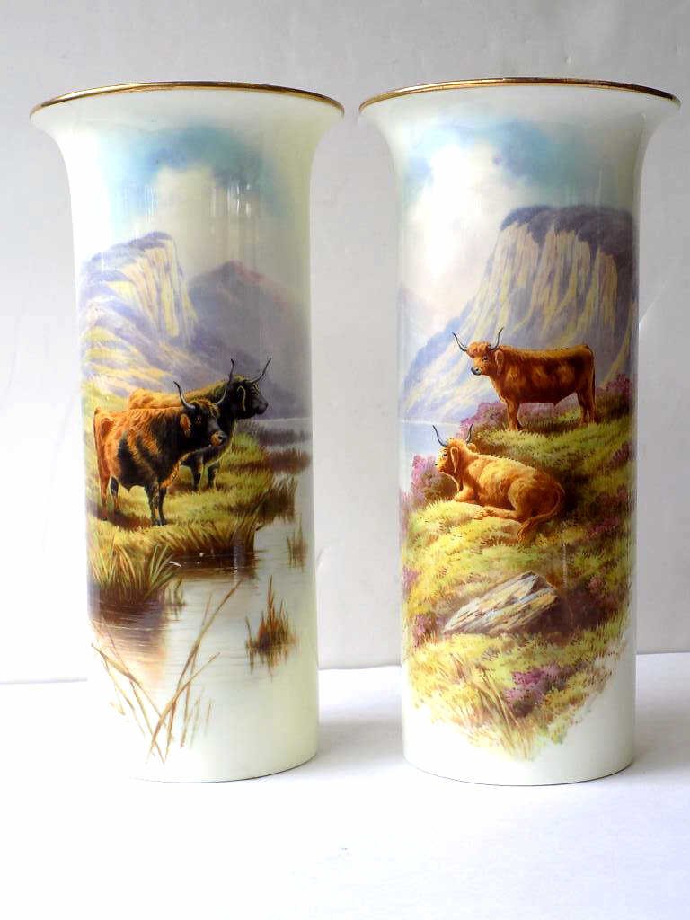 DONUE ENGLISH PORCELAIN STEERS CYLINDER VASES: Gaul Donue - English Pair of porcelain cylinder vases . Hand painted nature landscapes with mountain steers / bulls . Bases signed. H 9"