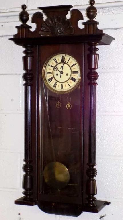 VICTORIAN VIENNA REGULATOR CLOCK: Victorian 19th Century Vienna Mahogany Regulator Wall Clock. Dual Corinthian Columns with finial topped urns aside a carved shell marquis. H 40" x W 7" x L 19. Original painted Porcelain face, brass P