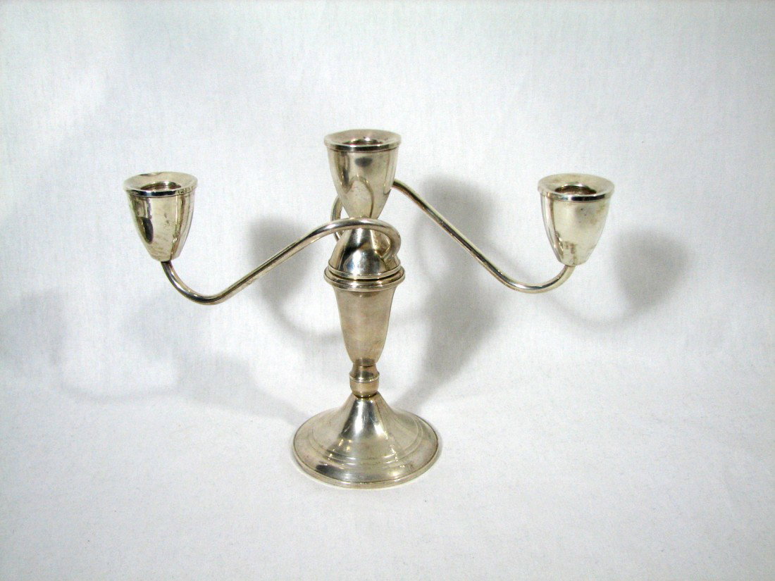 Sterling Silver Candalabra 7 3/4: Sterling Silver candelabra with nearly straight sided candle cups. Clean modern lines. Holds three tapered candles Measures 7 3/4 inches high x 10 1/2 inches wide. The side of one cup has a dent. Weig