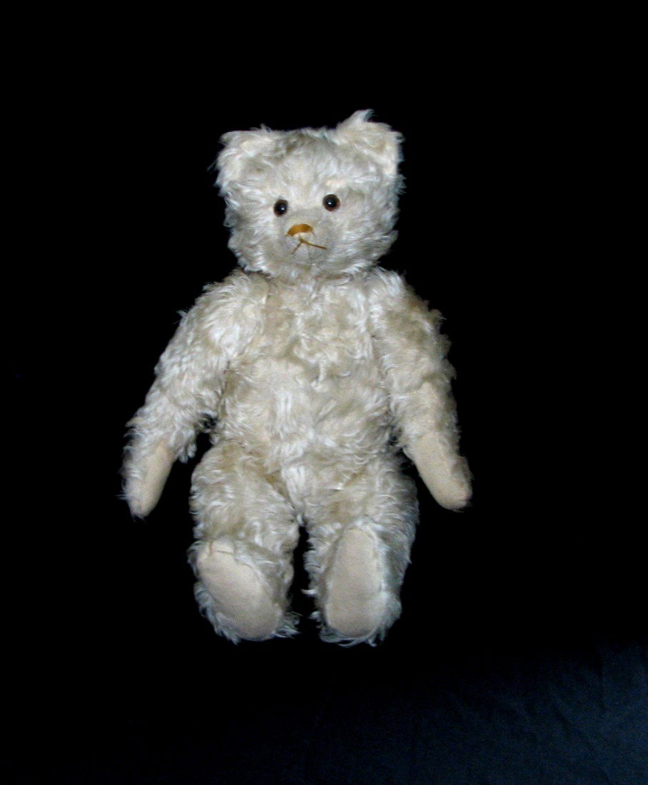 Antique White Mohair Teddy Bear: Fantastic antique teddy bear, crafted in long white mohair. Clean and still white. Orange nose. Glass eyes. When turned parts can be heard moving inside him. Smells fresh, from a non smoking estate. H