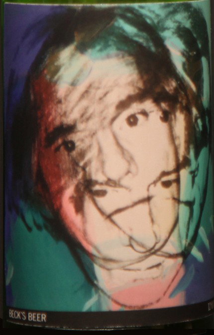 Self-Portrait: Closed bottle. Front label displays the self-portrait and the back label displays the year. Each bottle comes with their own showcase. (does not include bottle in the picture)