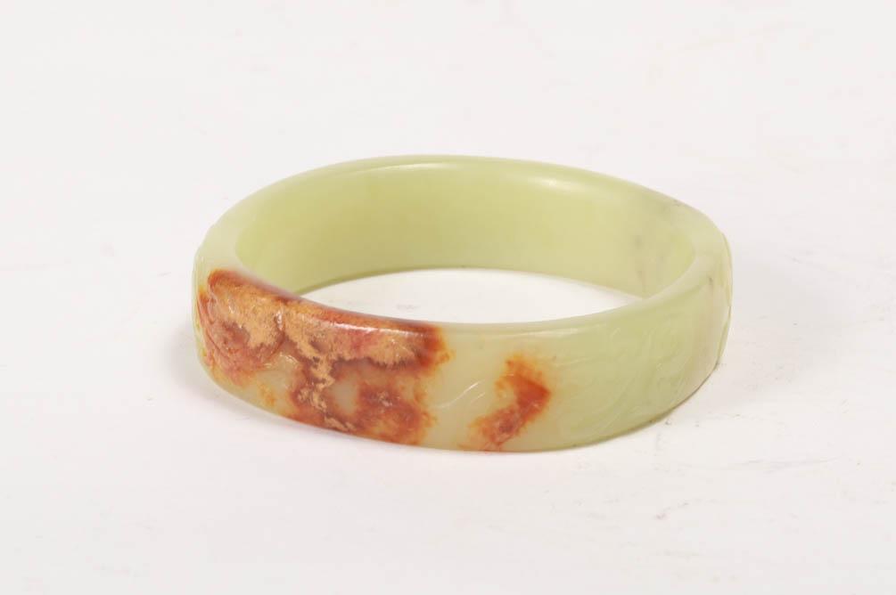 A CARVED YELLOW JADE "DRAGON" BRACELET (1 of 9)