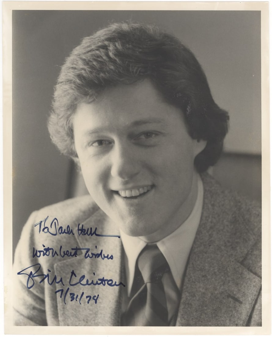 Bill Clinton Signed Early Photograph, Dated July 31, 1974 Signed Before His First Election: Bill Clinton, 42nd President of the United States, signed this black and white portrait in blue ink, inscribed "To Paula Helle, with best wishes, Bill Clinton, 7/31/74." The shows a strikingly young C
