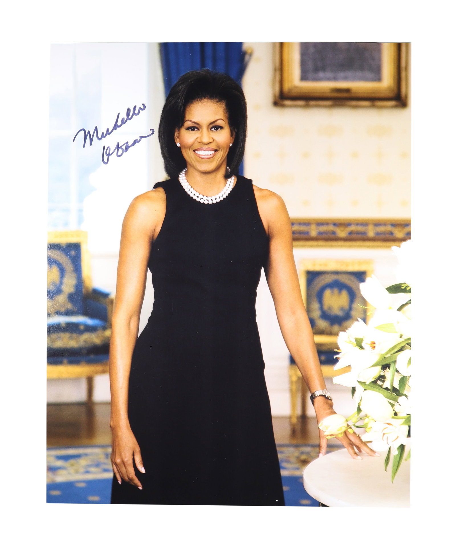 MICHELLE OBAMA SIGNED OFFICIAL WHITE HOUSE PORTRAIT PHOTOGRAPH: Michelle Obama (b. 1964), attorney, author, and First Lady of the United States from 2009 to 2017, signs her name boldly in blue ink across the upper left of this striking official White House portrai
