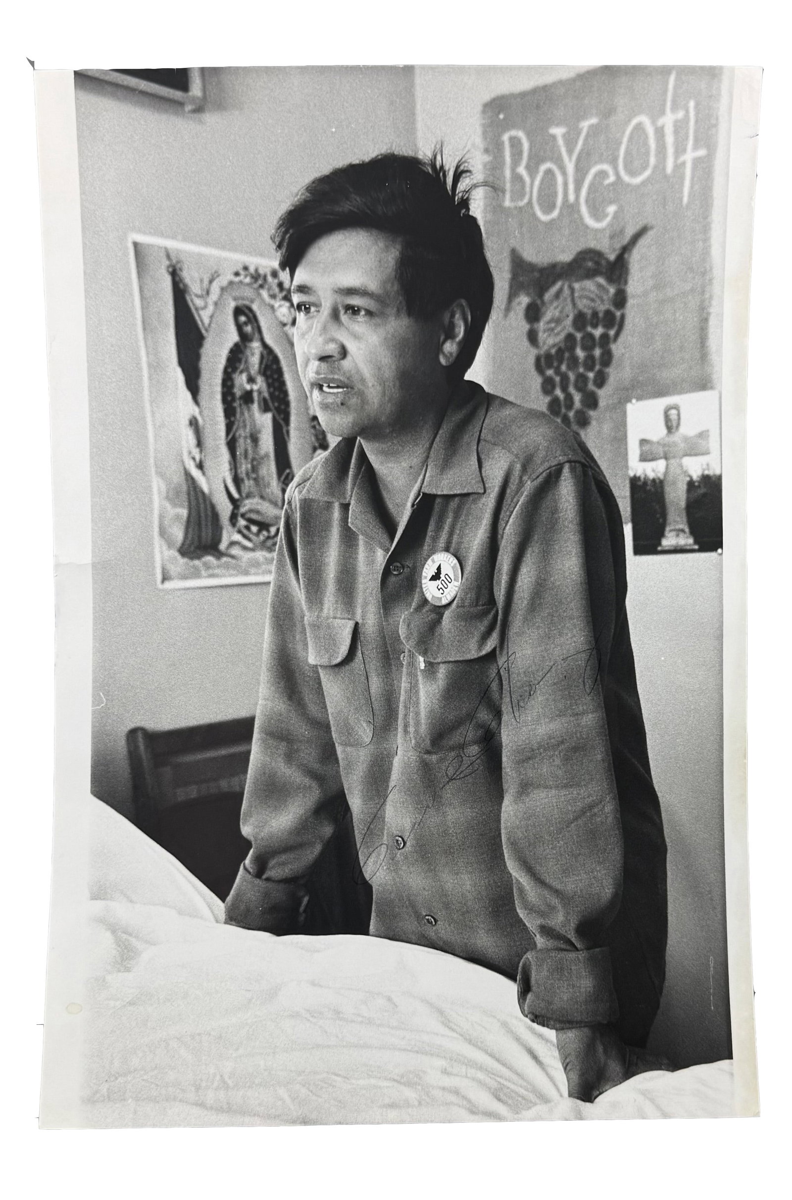 CESAR CHAVEZ SIGNED ASSOCIATED PRESS PRESS PHOTOGRAPH IN A SETTING OF EXCEPTIONAL SYMBOLIC POWER: This is among the most visually and historically resonant Cesar Chavez signed likely to appear at auction. The large format black and white Associated Press press shows Chavez standing beside what app