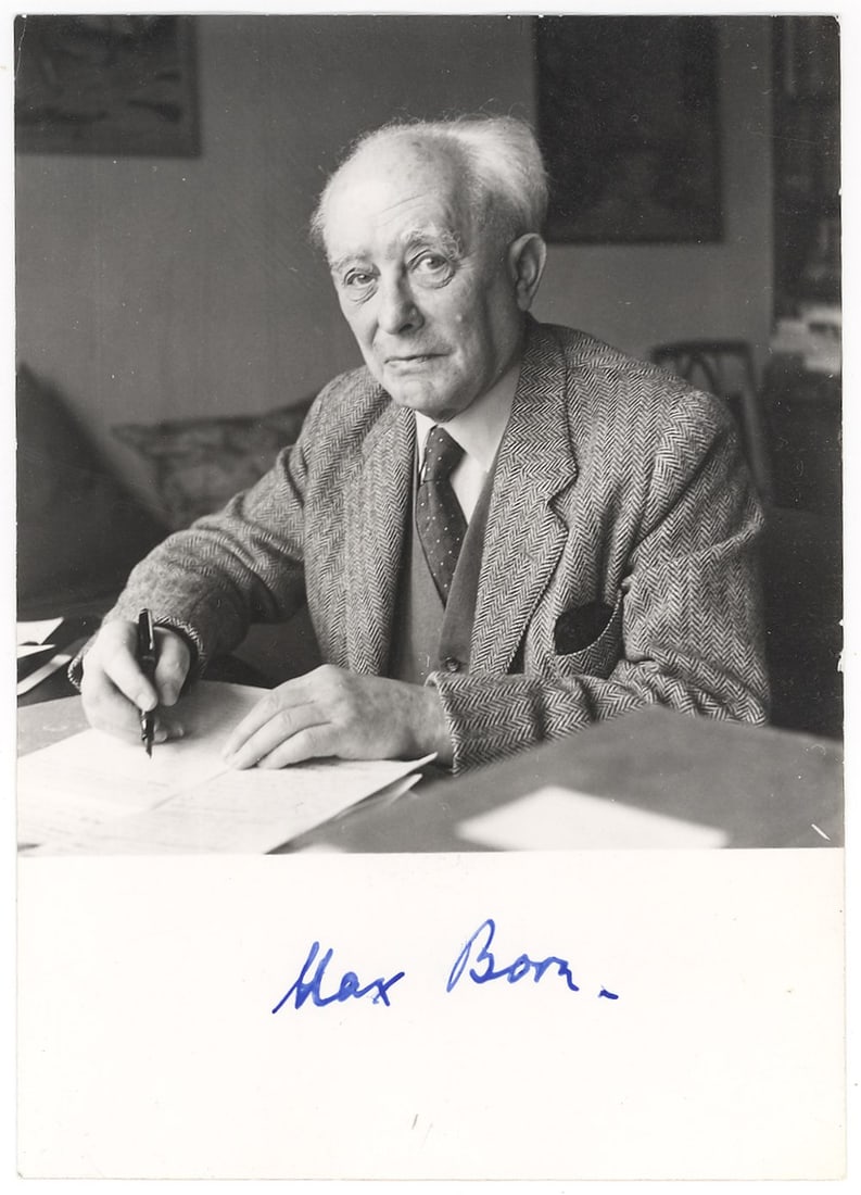 Max Born Signed Photograph with Photographer's Stamp, Nobel Laureate in Physics: Nobel Laureate in Physics. A fine original black and white depicting Max Born (1882-1970) seated at a desk, pen in hand, gazing directly at the camera. The captures the great physicist in a contemplat