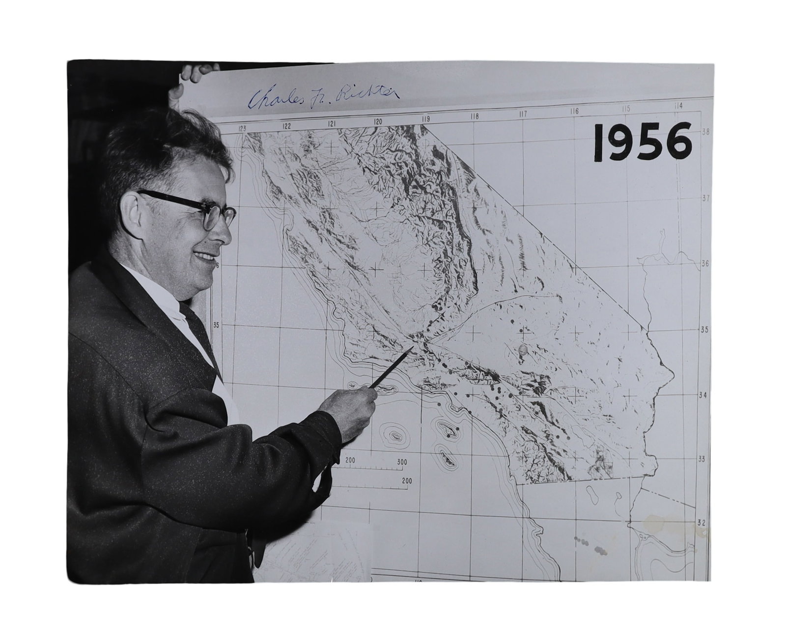 Charles Richter Signed Photograph Pointing to a Seismological Map of California, 1956: Charles Richter Signed Pointing to a Seismological Map of California, 1956. Charles F. Richter (1900-1985), American seismologist who, with Beno Gutenberg, developed the Richter magnitude scale in 193