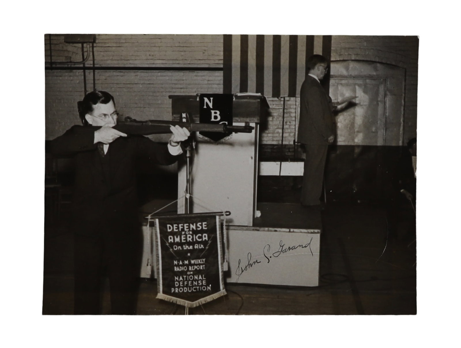 John C. Garand Signed Photograph Demonstrating His M1 Rifle on NBC's "Defense of America" Broadcast (1 of 1)
