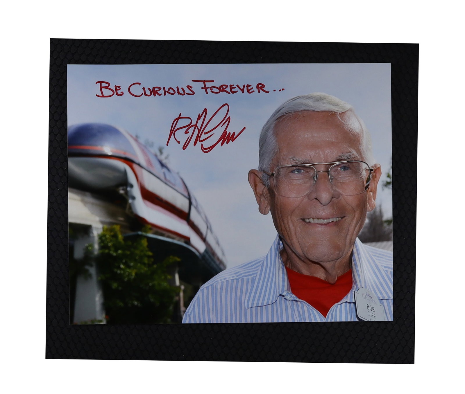 Robert Gurr Signed and Inscribed Photograph: "Be Curious Forever," Disneyland Ride Designer: Robert Gurr Signed and Inscribed: "Be Curious Forever," Disneyland Ride Designer. Robert Gurr (1931-2023), American mechanical engineer and Imagineer who designed some of Disneyland's most iconic ride
