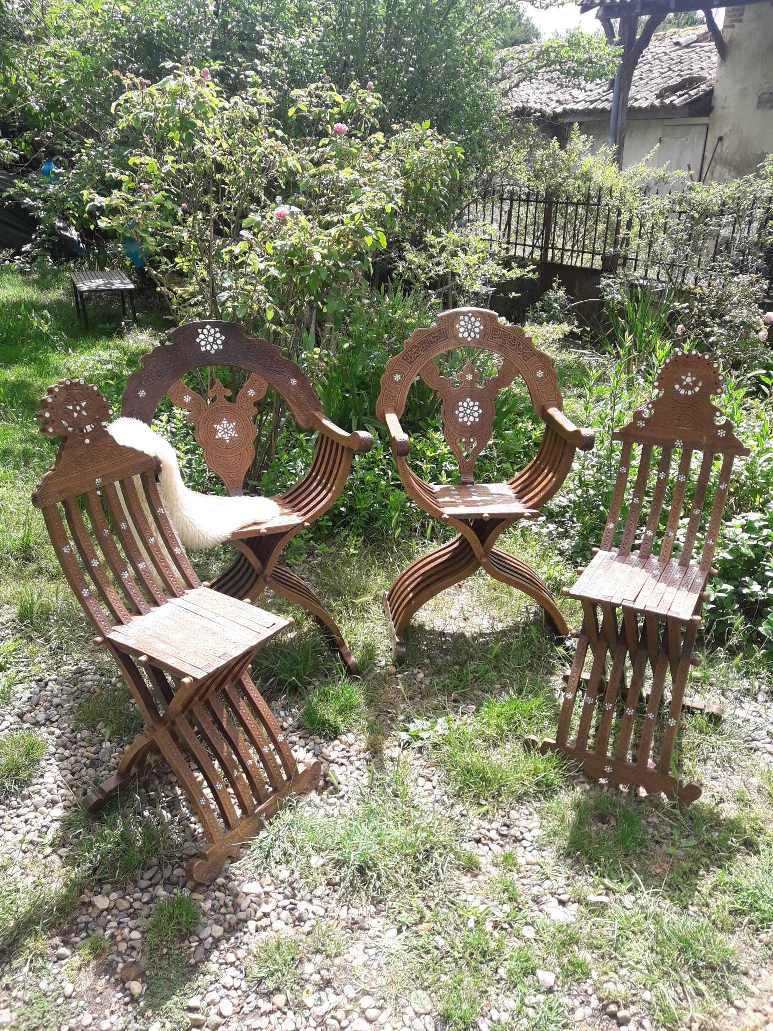 Ensemble Syrien comprenant deux fauteuils et deux chaises de style Dagobert pliants en bois: Ensemble Syrien comprenant deux fauteuils et deux chaises de style Dagobert pliants en bois sculpté incrusté de nacre, décorés d’inscriptions en Thuluth Fin du XIXe sièc