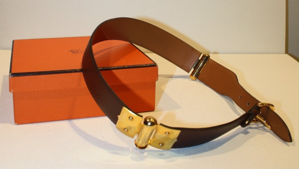 HERMES - Ceinture pour Dame en cuir grainé marron: HERMES - Ceinture pour Dame en cuir grainé marron ornée de deux décors à articulations en métal plaqué or, fermoir par boucle, taille 72, modèle rare, commande spéciale, état parfait dans sa