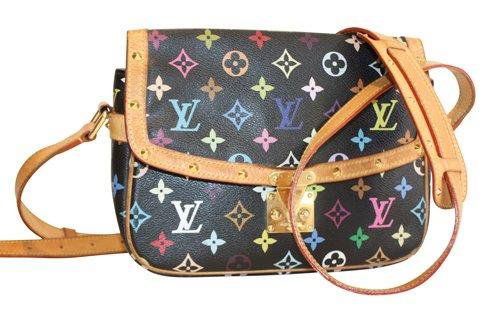 VUITTON- sac à rabat en toile monogrammée fond noi: VUITTON- sac à rabat en toile monogrammée fond noir et décor polychrome, cuir naturel, garniture en métal doré. Bon état