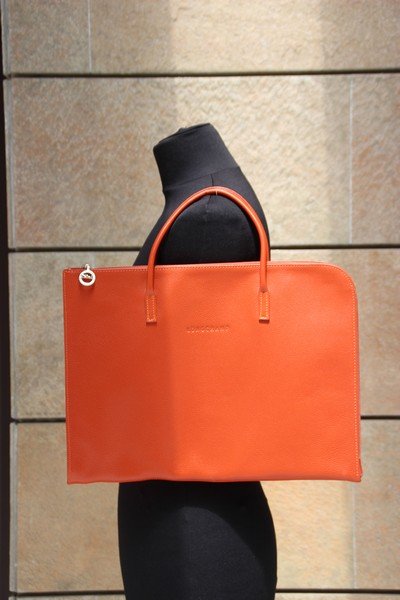 LONGCHAMP Porte-document plat pouvant Contenir un: LONGCHAMP Porte-document plat pouvant Contenir un ordinateur Portable en cuir grené corail Dimensions : 28 x 38 cm Bon état (dustbag)