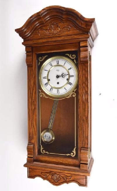 Sligh German Oak Wall Clock: Sligh German oak wall clock w/ carved detailing on top and bottom, Style No.0769-1-BE, movement series 310 side hammer, Franz Hermle, 32.5" L x 15" W x 7.75" D. Contact our recommended 3rd party "for