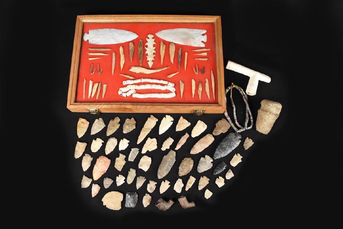 Large Collection of Indian Artifacts: Collection of Indian artifacts including 2 trade pipes, Clovis, arrow heads, ax stone (4" x 2 1/4"), hooks a ceremonial spear point, bone tools and more. Contact our recommended 3rd party "for profit"