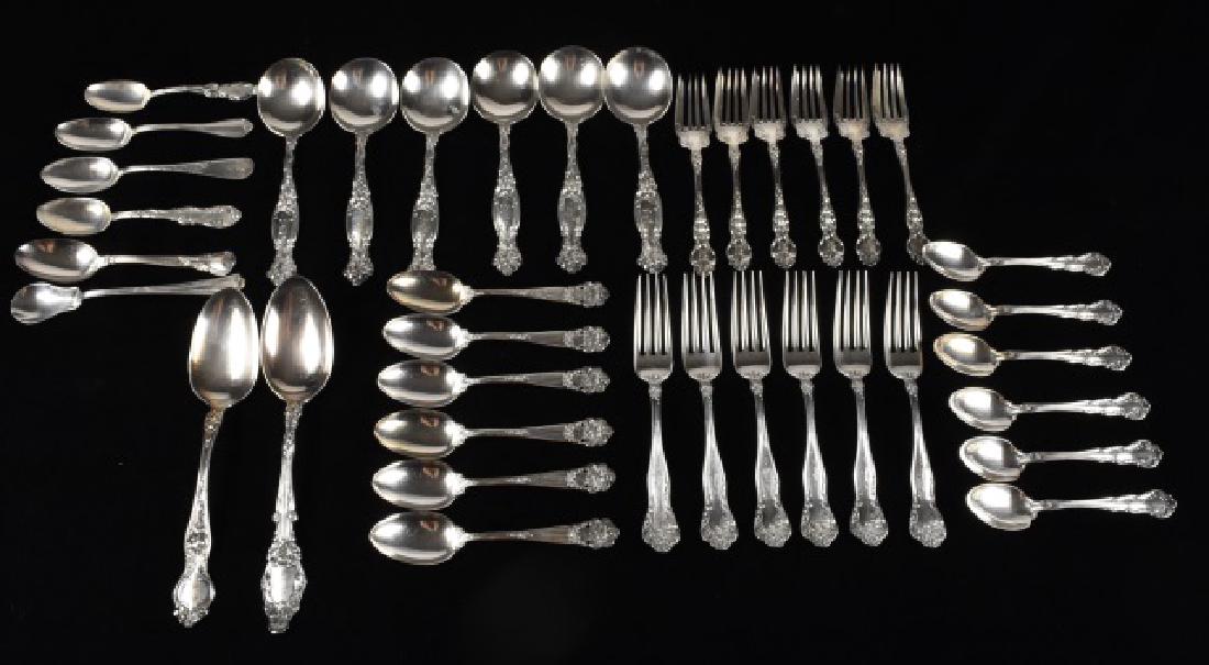 Assortment of Sterling Silverware: Large assortment of sterling silverware that includes 6 spoons that have roses atop a column at the end of the handle; 5", 6 spoons with floral scrolls around the edges of the handle made by R. Wallac
