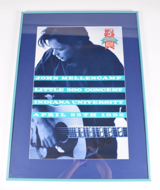 Autographed Poster John Mellencamp, 1992: Autographed poster of John Mellencamp in a turquoise frame and royal blue matting from the John Mellencamp Little 500 Concert at Indiana University on April 25, 1992. It is signed in the lower right c
