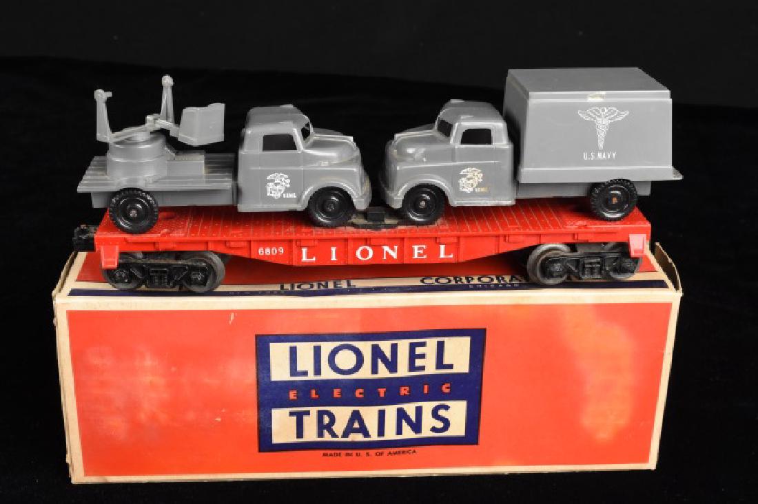 Lionel 6809 Flat Car with Military Units: Lionel 6809 Flat Car with USMC Anti-Aircraft and Medical Truck in tow with original box. This Flat Car and components are in good used condition but need cleaned up a bit. The box is in average used c