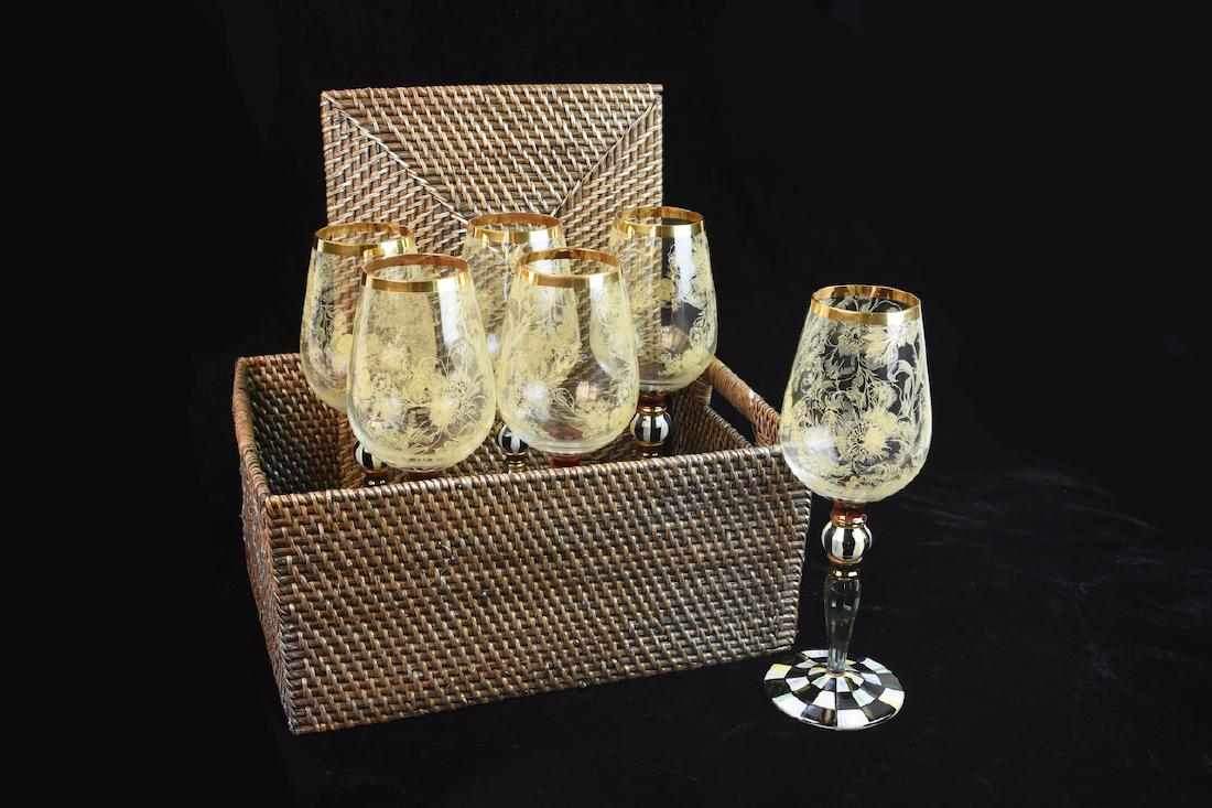 MacKenzie Childs Blooming Wine Glasses: (6) Retired MacKenzie-Childs hand painted Blooming Wine glasses. Each glass features a gold rim, lacy garden flowers and hand painted black, red, white and gold striped and checkered stem. These glass