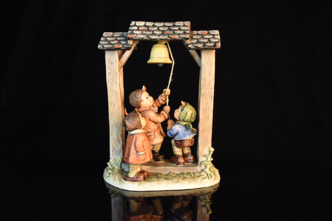 Hummel Figurine "Let's Tell The World"; OB: 1990 Goebel Hummel figurine titled "Let's Tell The World" 487, TMK-6, signed GTA 912. This Hummel is from the Century Collection and is in very good condition with the original box and medal. It stand