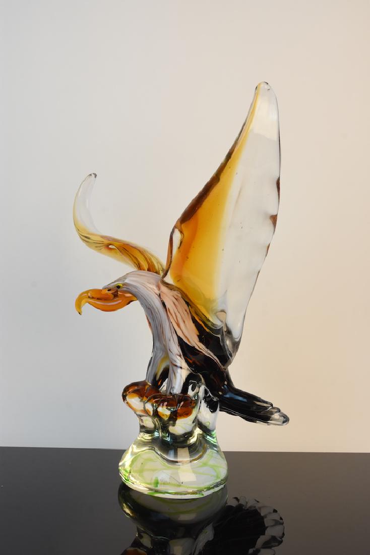 Dale Tiffany Art Glass Eagle Statue: Dale Tiffany art glass eagle with wings spread wide in dark brown marbled with white, amber and clear glass. Perched upon a sturdy clear glass base this fearless eagle stands 13 1/2" tall and approx. 