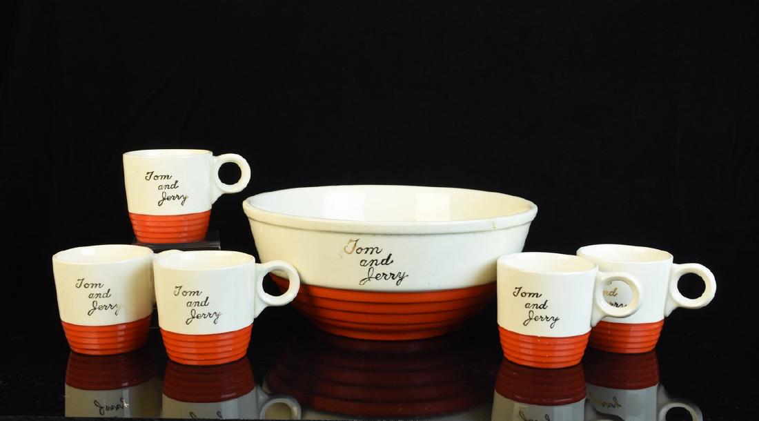 Universal Pottery Tom & Jerry Mugs and Bowl: Made in the USA Universal Pottery set featuring (5) Tom and Jerry pottery mugs and 10" bowl. This matching set is ivory on the top and orange on the bott with Tom and Jerry written in gold. This 1950'