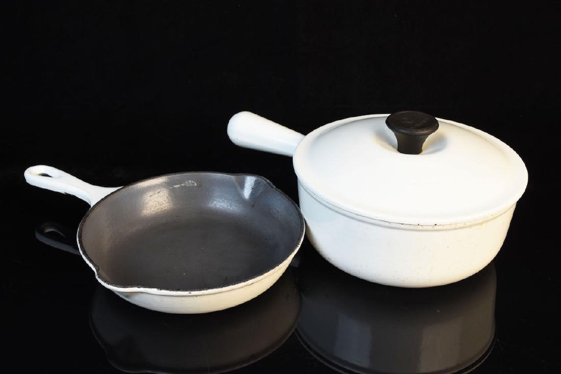 Le Creuset #20 Cast Iron Skillet & Pot: Le Creuset #20 white 7 1/2" double spout skillet and lidded 8" saucepan. This cookware is in fair used condition with wear to the white finish. Contact our recommended 3rd party "for profit" shipper P